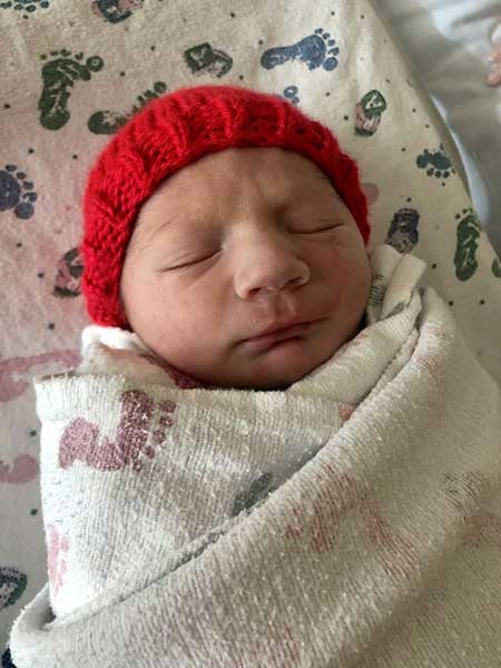Newborn baby with a red hat