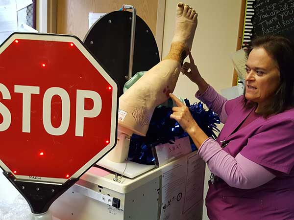 Nurse demonstrating pressure injury location